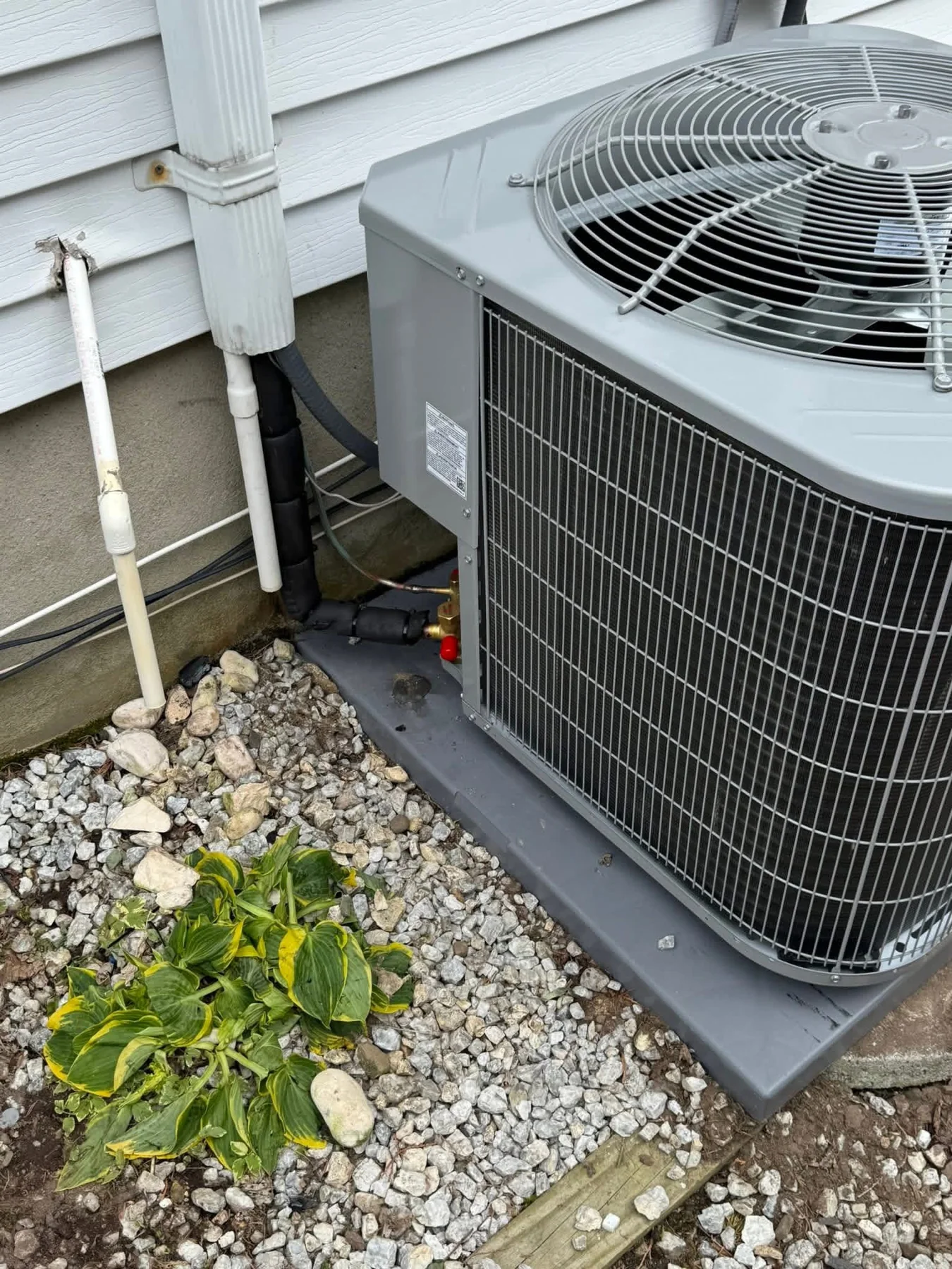 Close view of HVAC condenser and refrigerant lines
